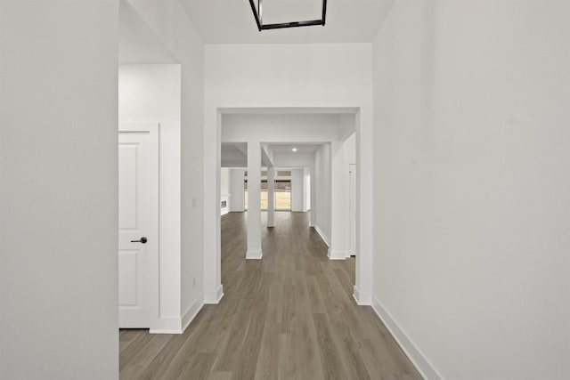 corridor with light hardwood / wood-style flooring