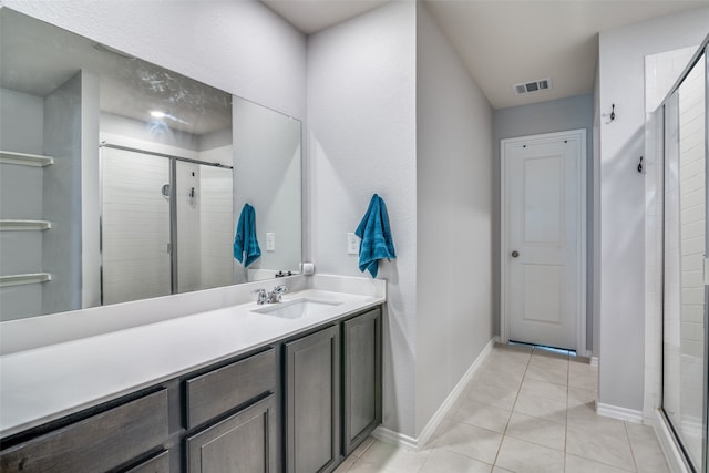 bathroom with vanity, tile patterned floors, and walk in shower