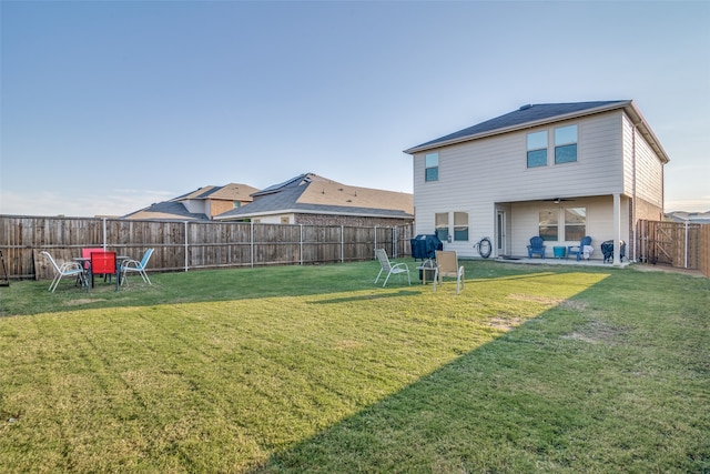 back of property featuring a lawn