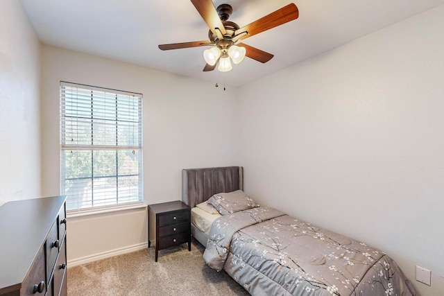 bedroom with ceiling fan and light colored carpet