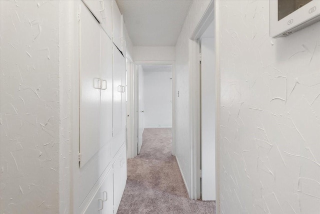 hall with light colored carpet
