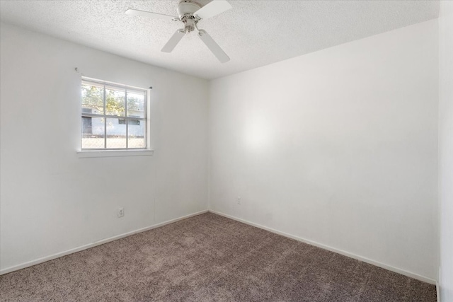 empty room featuring ceiling fan, carpet, and a textured ceiling