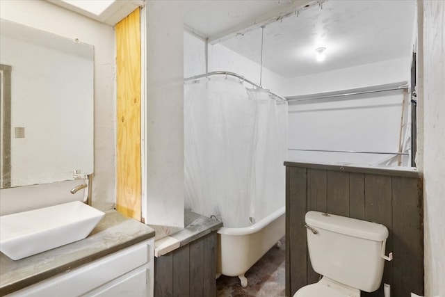 full bathroom featuring toilet, wood walls, shower / bath combo, and vanity