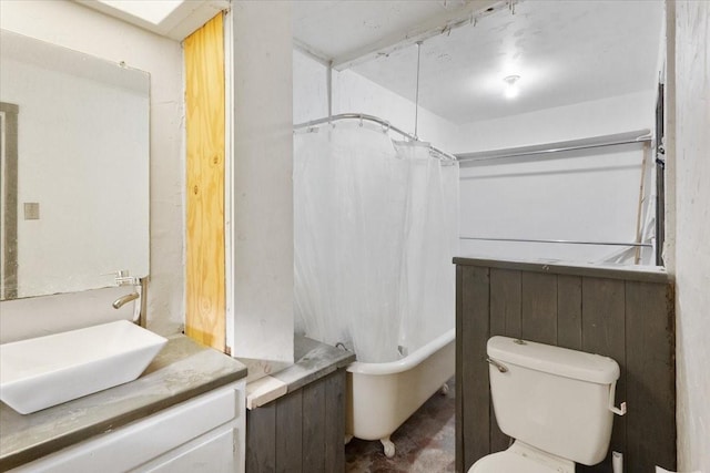 bathroom featuring vanity, shower / bathtub combination with curtain, and toilet