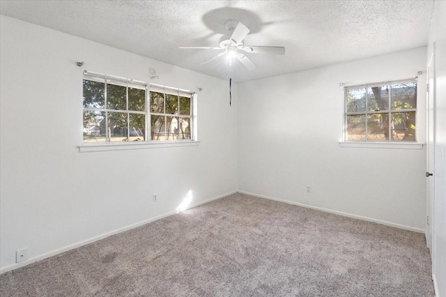 spare room with baseboards, a ceiling fan, carpet flooring, and a textured ceiling
