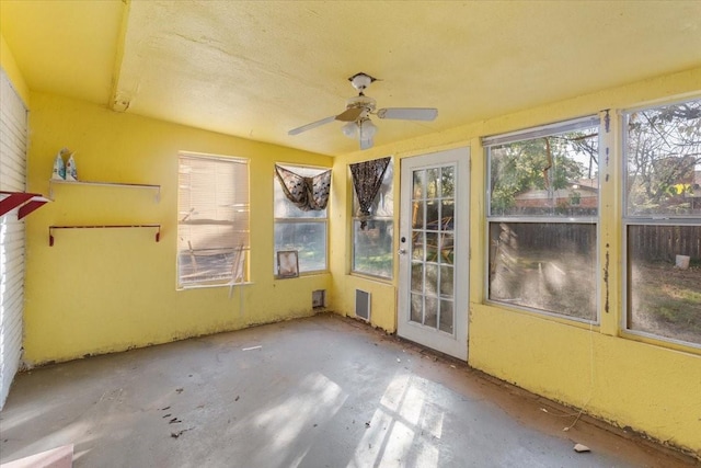 unfurnished sunroom featuring ceiling fan