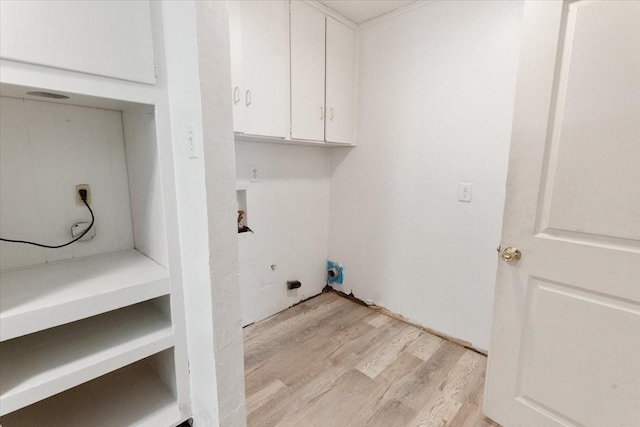 washroom with washer hookup, hookup for an electric dryer, light wood-type flooring, and cabinet space