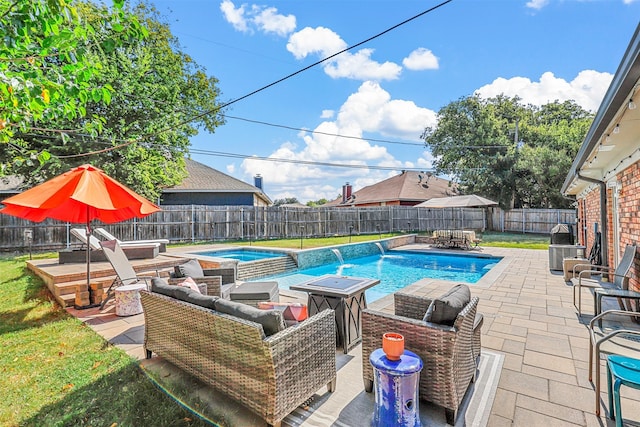 view of pool featuring a patio area, pool water feature, and an outdoor living space