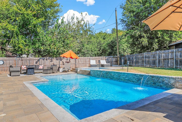 view of swimming pool with an outdoor living space, pool water feature, and a patio area