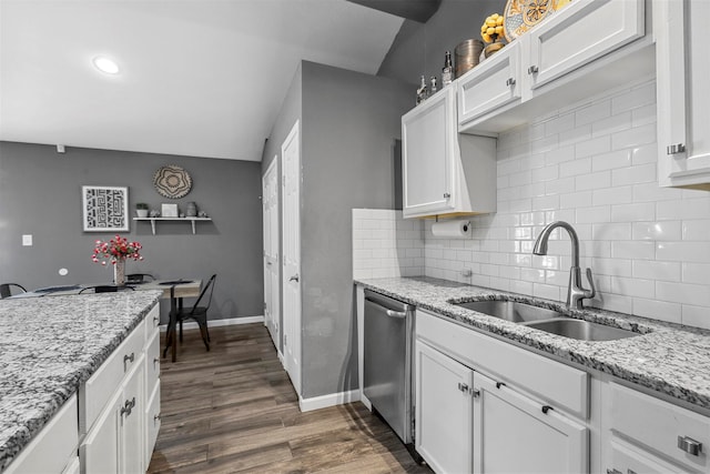 kitchen with stainless steel dishwasher, white cabinetry, sink, and dark wood-type flooring