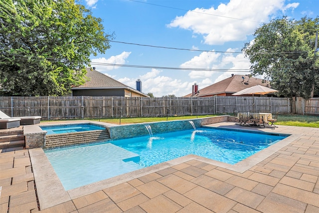 view of swimming pool with a patio area, pool water feature, and an in ground hot tub