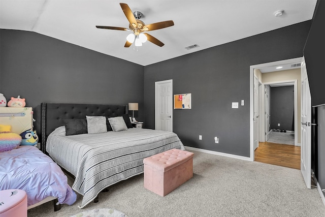 carpeted bedroom featuring ceiling fan and vaulted ceiling