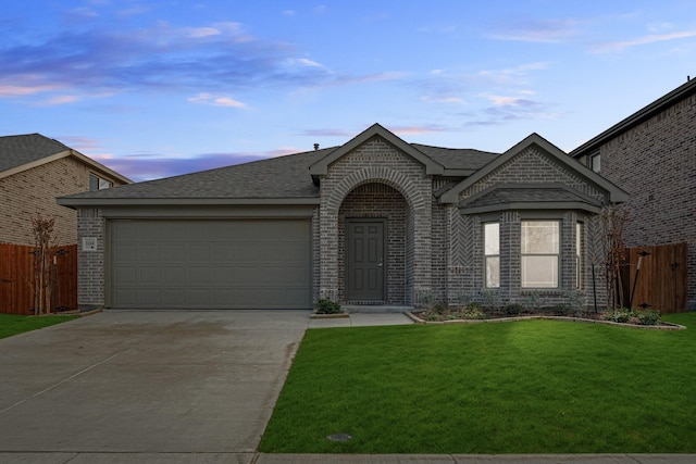 view of front of house with a yard and a garage