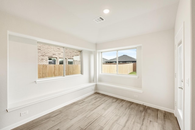 spare room with light hardwood / wood-style floors