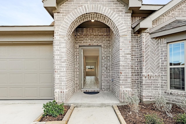 doorway to property with a garage