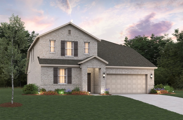 view of front of home with a garage and a yard