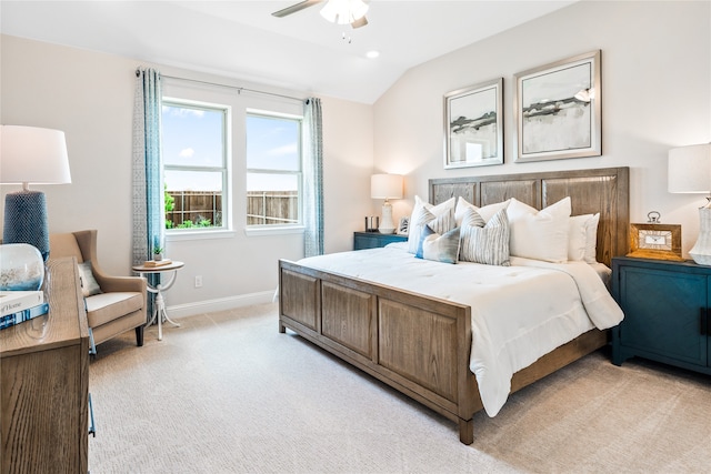 bedroom featuring lofted ceiling, light colored carpet, and ceiling fan