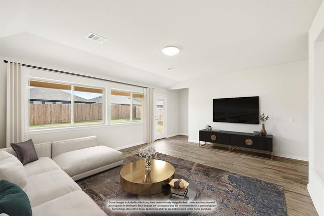 sitting room featuring light carpet and lofted ceiling