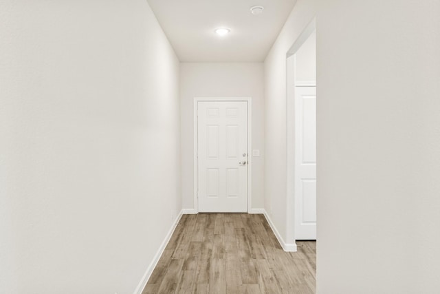 hall with light hardwood / wood-style floors