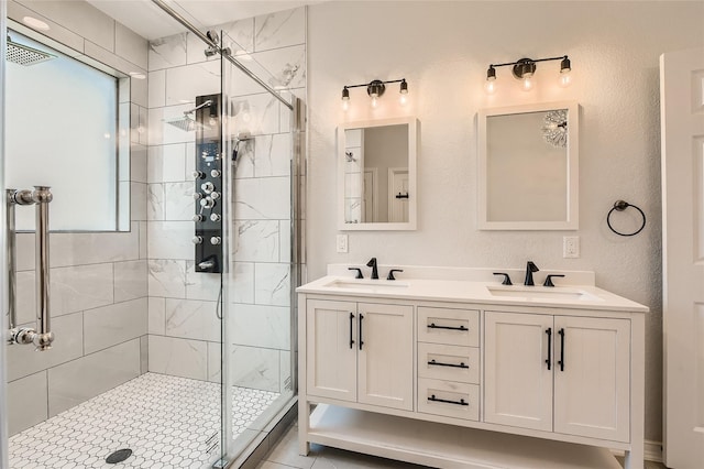 bathroom featuring vanity, a wealth of natural light, and a shower with door