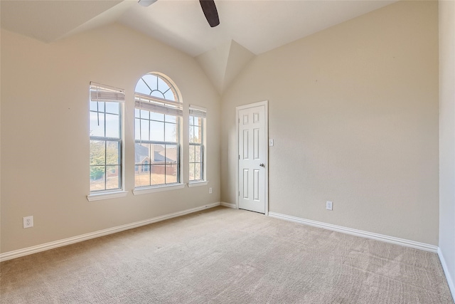 carpeted spare room featuring ceiling fan and lofted ceiling