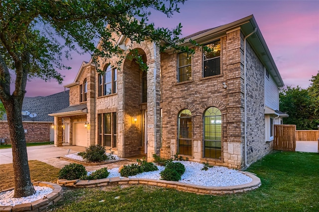 view of front of house featuring a garage and a lawn