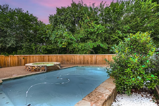 view of pool at dusk