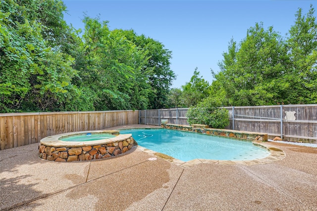 view of pool with an in ground hot tub and a patio