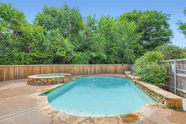 view of swimming pool with an in ground hot tub