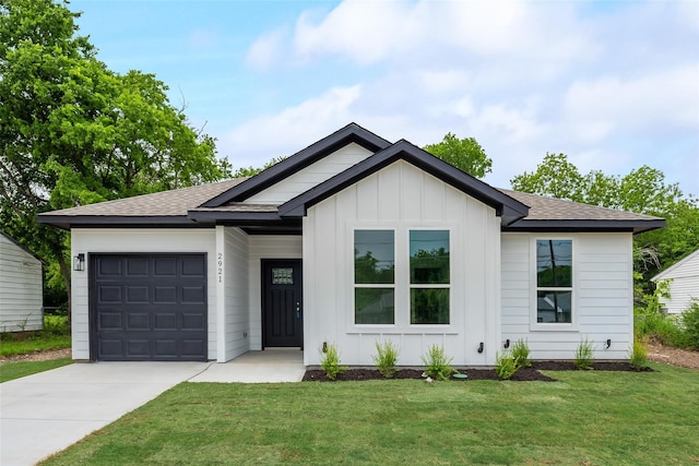 modern farmhouse featuring a front lawn and a garage