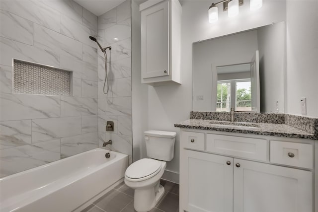 full bathroom with toilet, tiled shower / bath combo, vanity, and tile patterned flooring