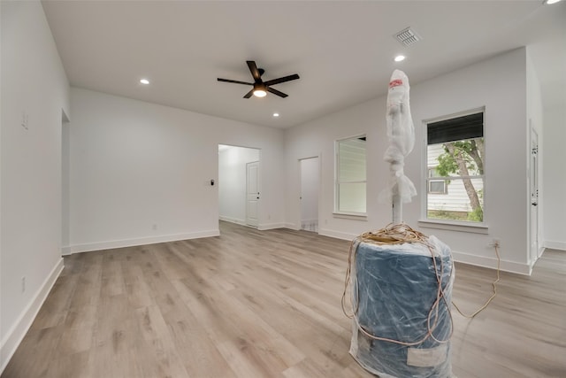 living room with light wood-type flooring and ceiling fan