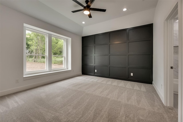 spare room featuring light carpet and ceiling fan