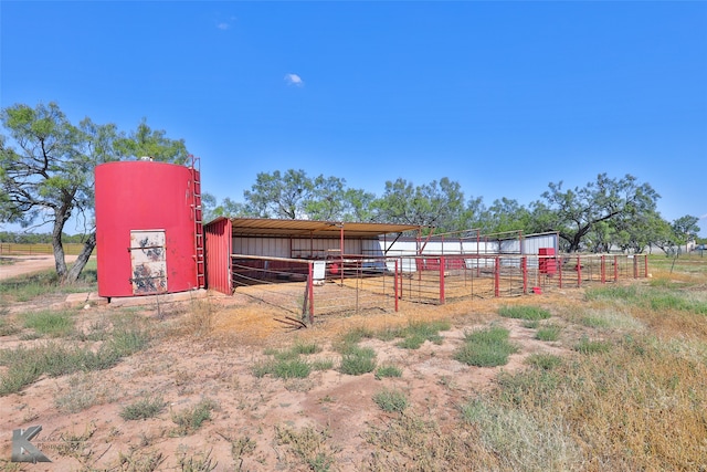 view of stable featuring a rural view