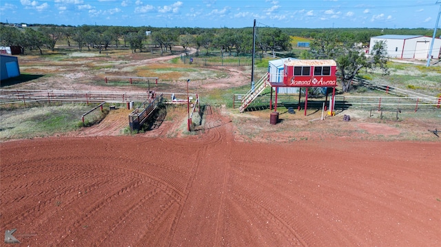 birds eye view of property with a rural view