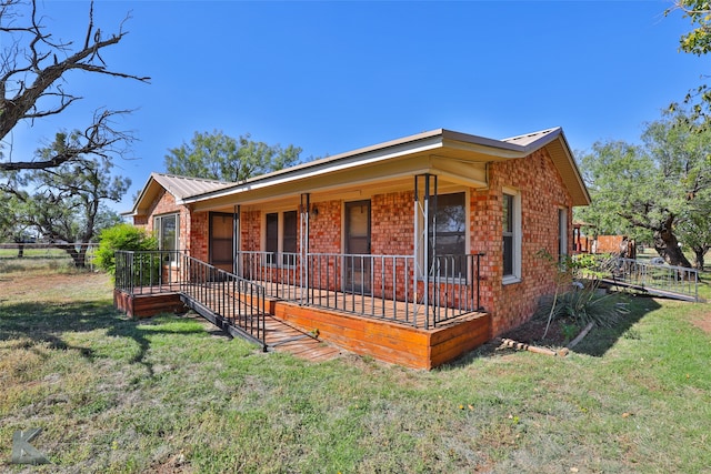 view of front of house with a porch and a front lawn