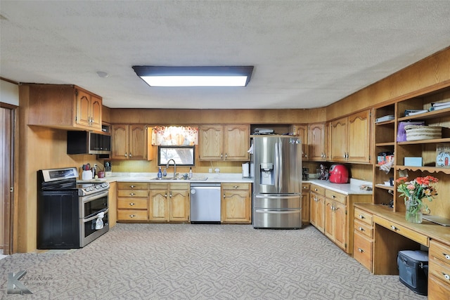 kitchen featuring a textured ceiling, sink, and appliances with stainless steel finishes