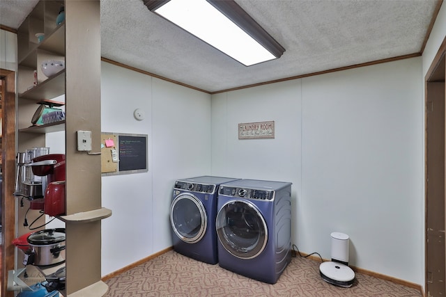 washroom featuring crown molding, washer and clothes dryer, light colored carpet, and a textured ceiling