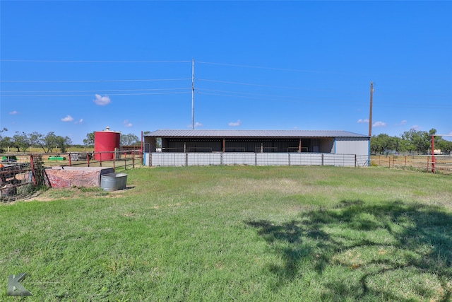 view of yard featuring a rural view and an outbuilding