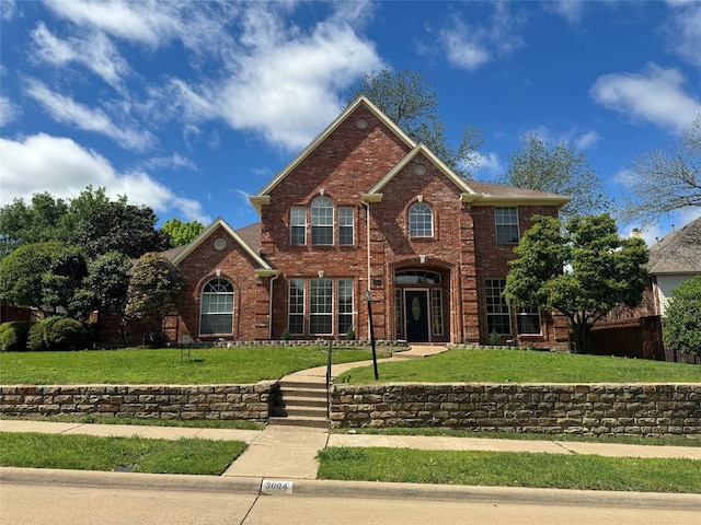 view of property featuring a front lawn