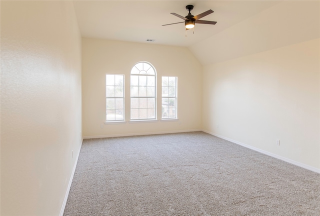 spare room featuring lofted ceiling, carpet floors, and ceiling fan