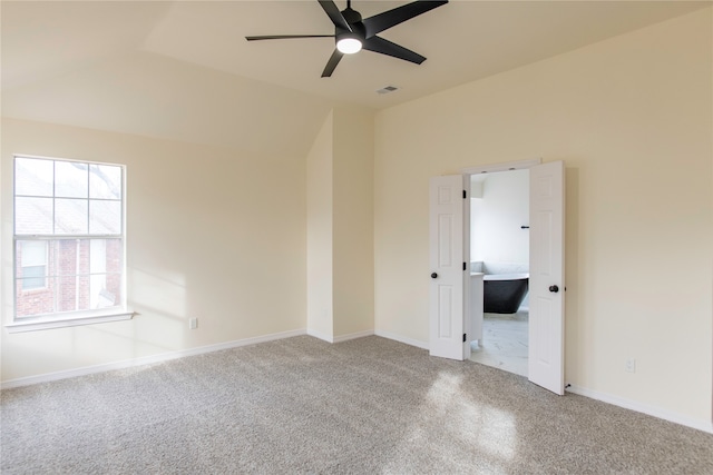 carpeted empty room with ceiling fan and vaulted ceiling