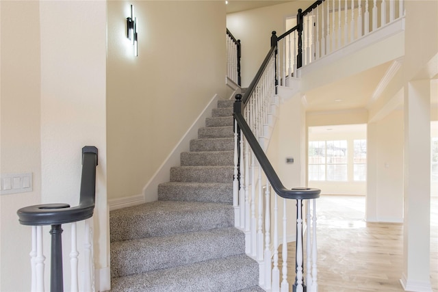 3004 Normandy Dr, Mckinney, TX 75070 - stairway featuring wood finished floors, baseboards, and a towering ceiling