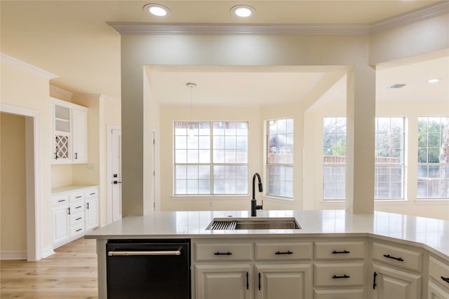 kitchen with white cabinetry, sink, and a wealth of natural light