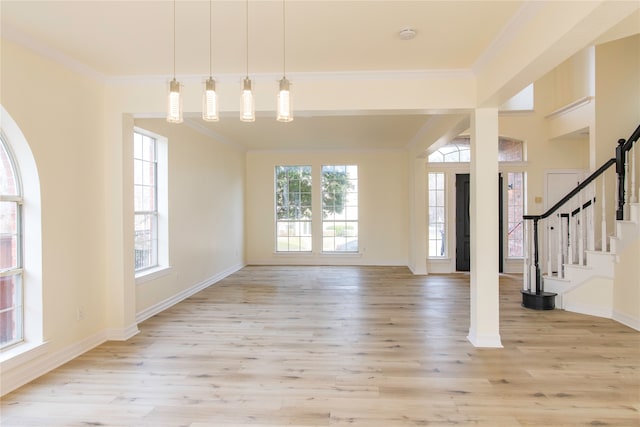 foyer entrance featuring light hardwood / wood-style floors and crown molding