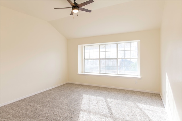 carpeted empty room featuring ceiling fan, plenty of natural light, and vaulted ceiling