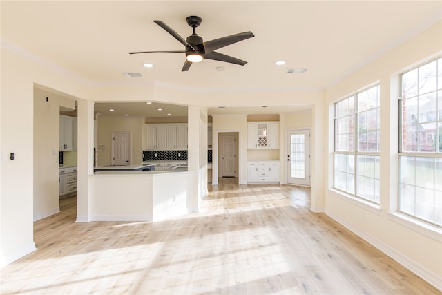 unfurnished living room with crown molding, light hardwood / wood-style flooring, plenty of natural light, and ceiling fan