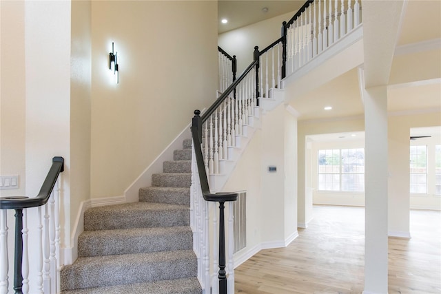 3004 Normandy Dr, Mckinney, TX 75070 - stairs with wood finished floors, ornamental molding, baseboards, a towering ceiling, and recessed lighting