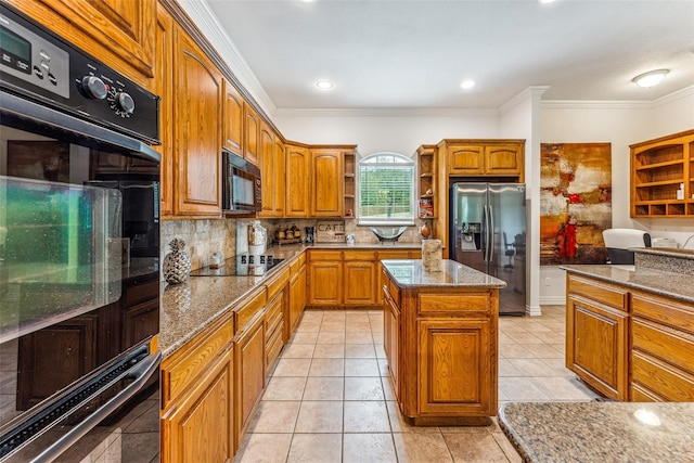 kitchen featuring black appliances, a kitchen island, crown molding, and stone counters