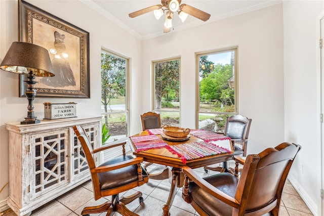 dining area featuring crown molding, plenty of natural light, and light tile patterned flooring